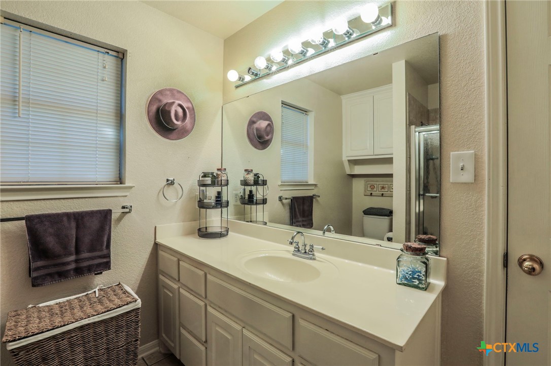 17 South Archer Drive Morgan's Point Resort, TX 76513 - Photo 14 of 30 a bathroom with a double vanity sink and a mirror
