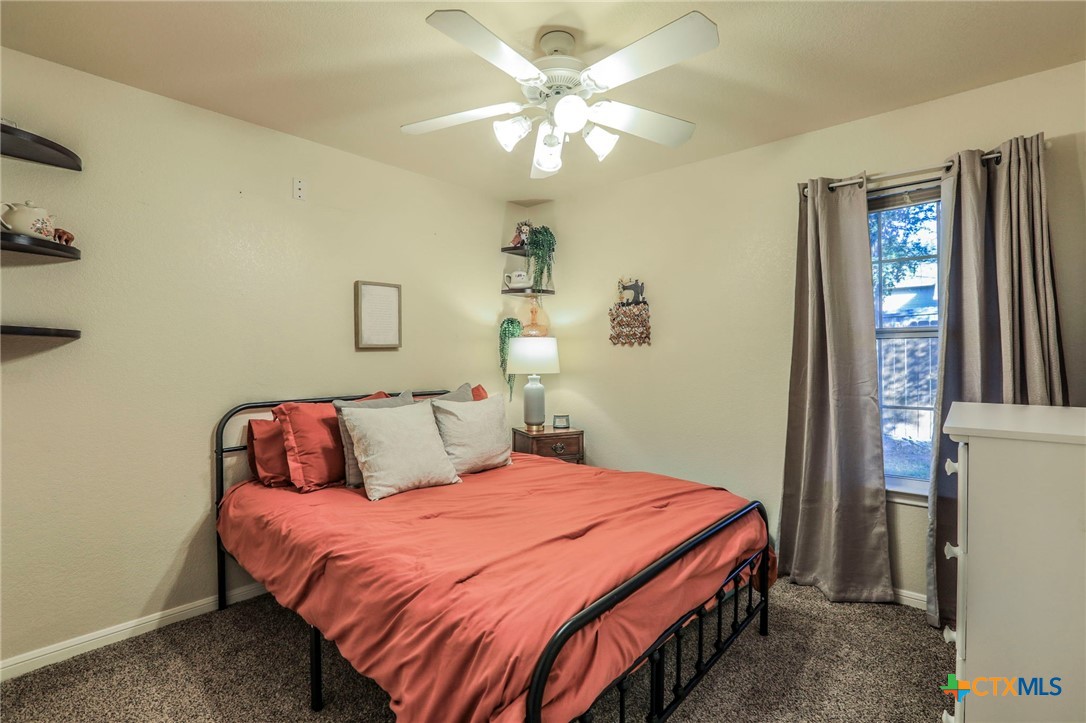 17 South Archer Drive Morgan's Point Resort, TX 76513 - Photo 15 of 30 a bedroom with a bed and a chandelier