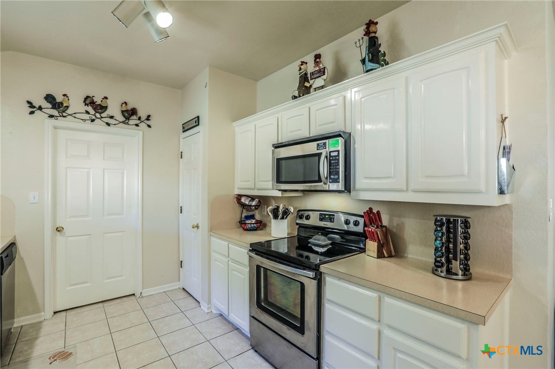 17 South Archer Drive Morgan's Point Resort, TX 76513 - Photo 8 of 30 a kitchen with stainless steel appliances granite countertop white cabinets a stove top oven a sink and dishwasher