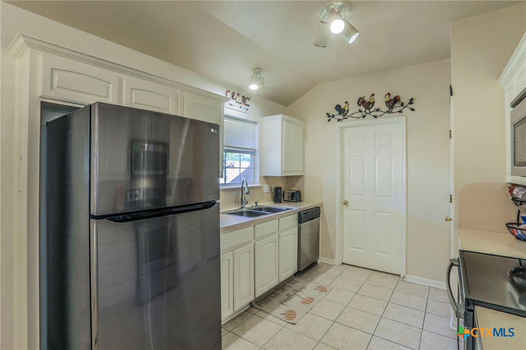 17 South Archer Drive Morgan's Point Resort, TX 76513 - Photo 9 of 30 a kitchen with stainless steel appliances a refrigerator and a sink