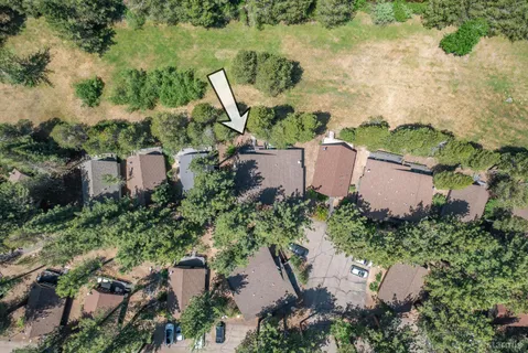 an aerial view of a house with a yard and lake view