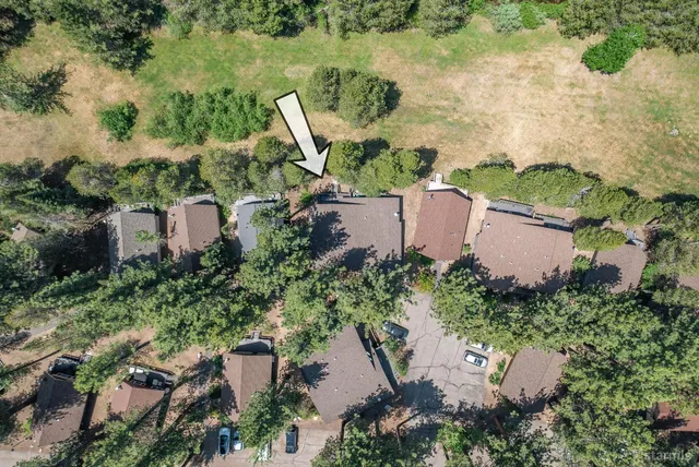 an aerial view of a house with a yard and lake view