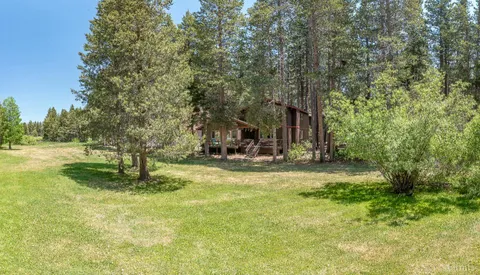a swimming pool with trees in the background