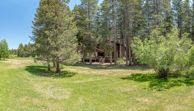a swimming pool with trees in the background
