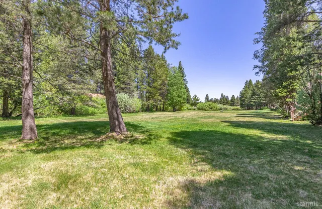 a view of outdoor space with deck and yard