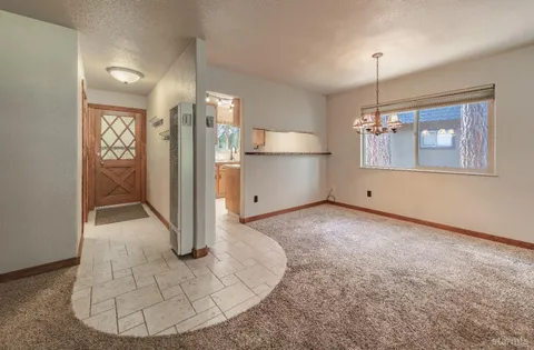 a view of a livingroom with a fireplace and window