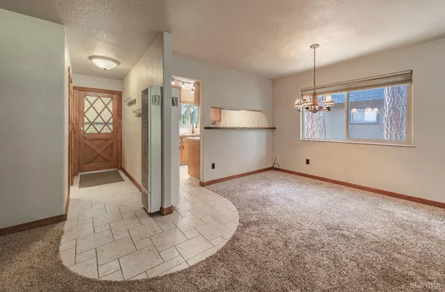 a view of a livingroom with a fireplace and window