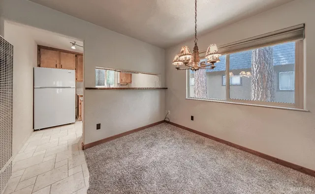 a view of a room with window and chandelier