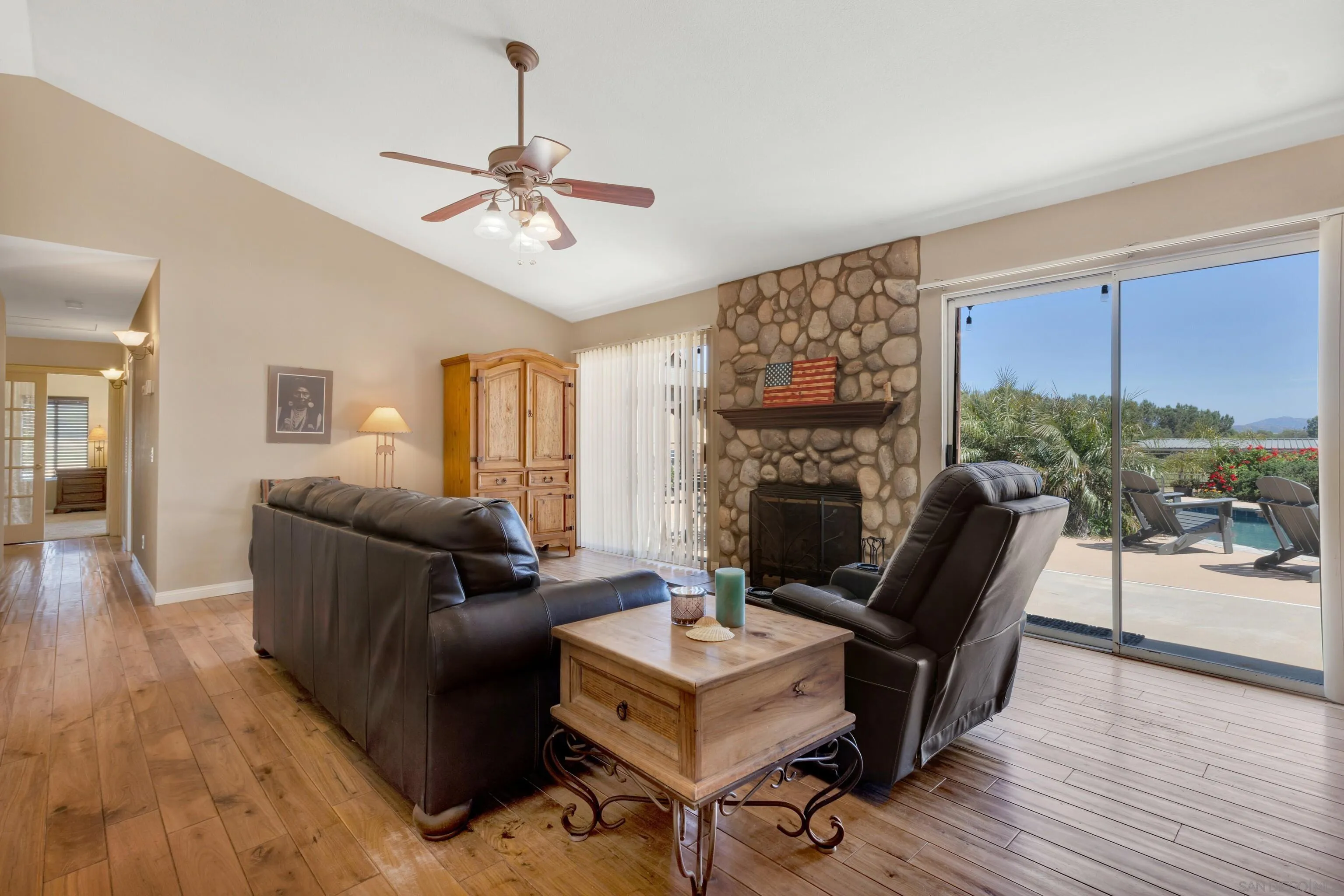 786 Rancho Trail Ramona, CA 92065 - Photo 17 of 49 a living room with furniture a fireplace and a floor to ceiling window