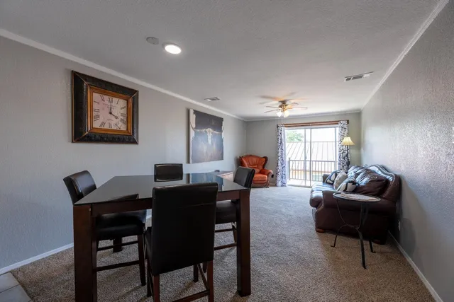 a living room with furniture a window and a flat screen tv