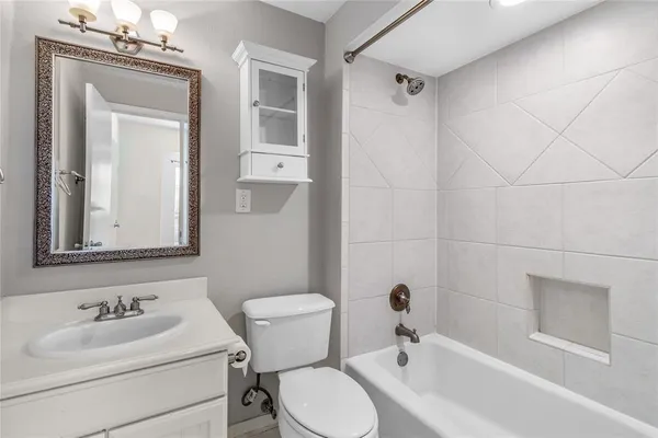 a bathroom with a sink toilet a mirror and shower