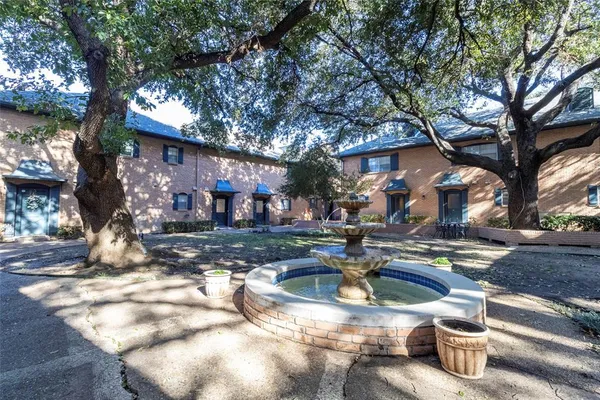 a view of a water fountain in front of a house