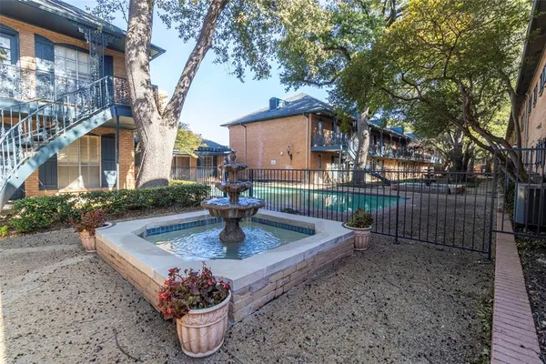 a view of a backyard with sitting area and tree