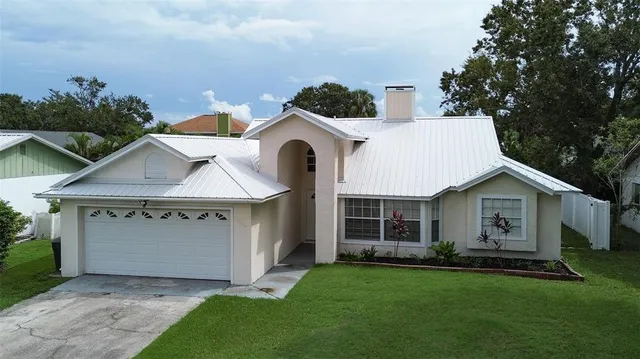 a front view of a house with a garden and yard