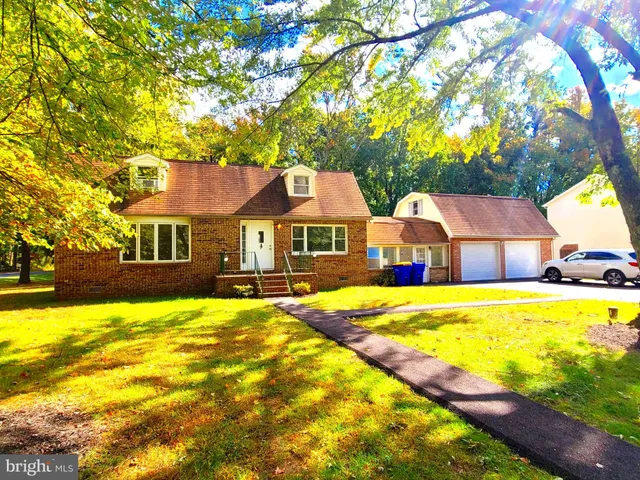 a front view of house with yard and swimming pool