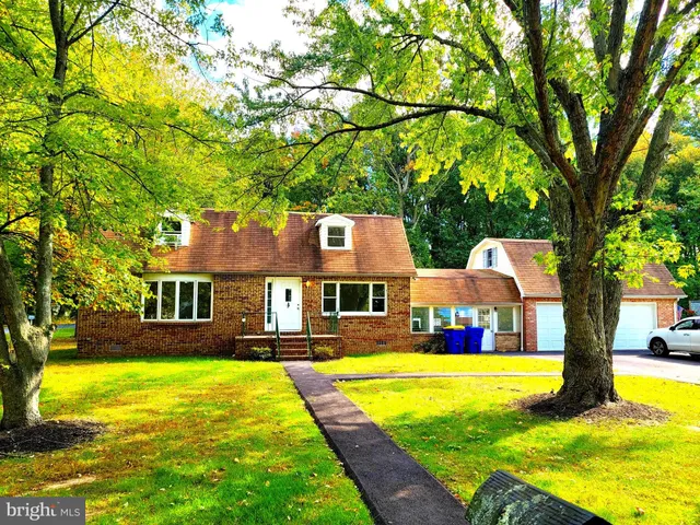a front view of house with yard and swimming pool