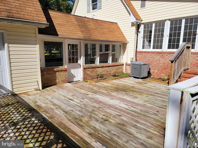 a view of a house with a barbeque and wooden floor
