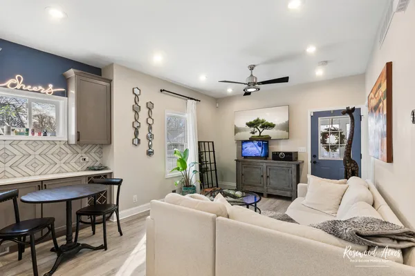 a living room with furniture and kitchen view