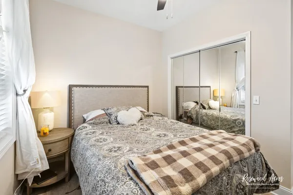 a bedroom with a bed and a mirror