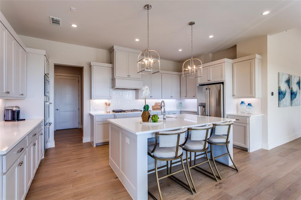 2116 Sicily Lane Haslet, TX 76052 - Photo 14 of 17 a kitchen with stainless steel appliances kitchen island granite countertop a table chairs and a refrigerator