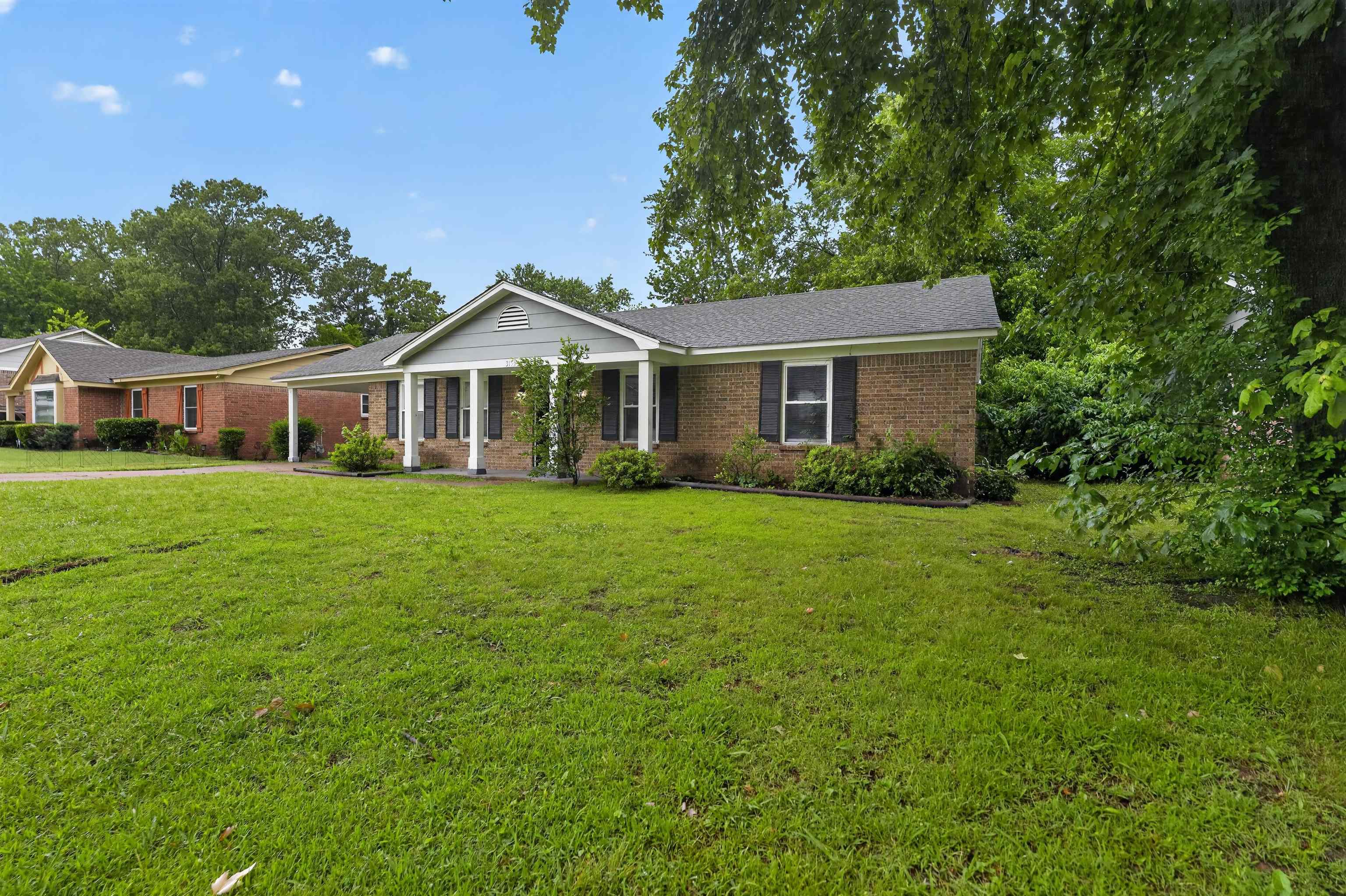 3152 Mackham Avenue Memphis, TN 38118 - Photo 5 of 16 Brick exterior featuring a covered front porch with white columns, dark shutters, and a gray gable
