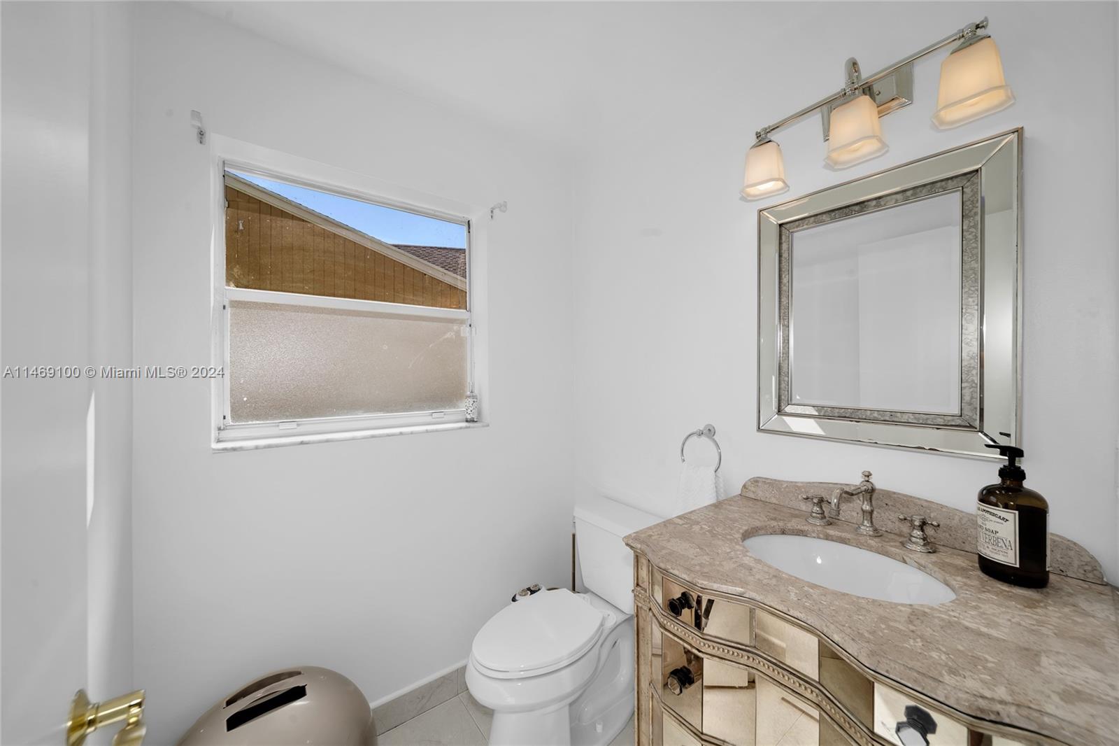 12083 Rockwell Way Boca Raton, FL 33428 - Photo 14 of 47 a bathroom with a granite countertop toilet a sink and a mirror