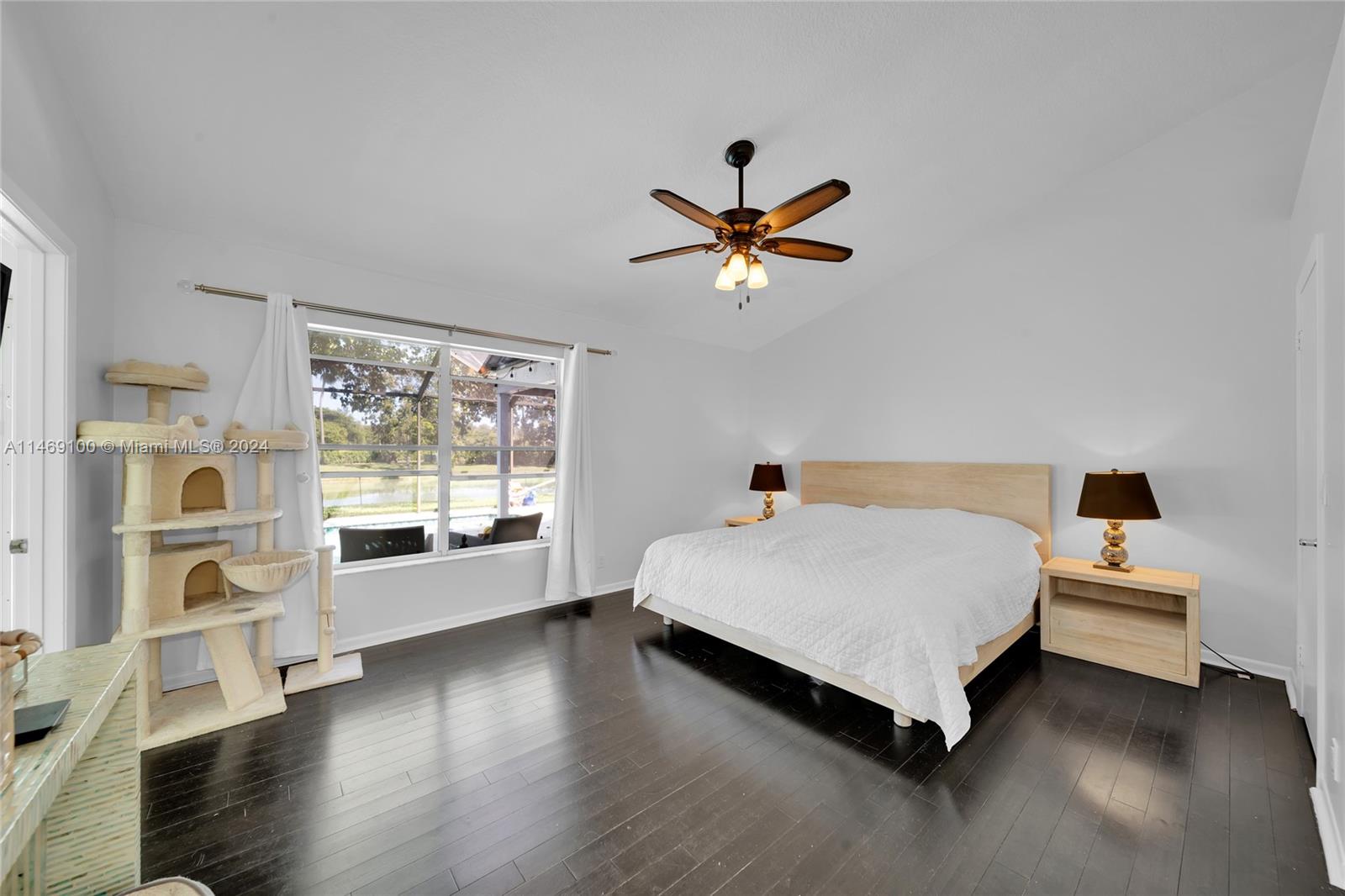 12083 Rockwell Way Boca Raton, FL 33428 - Photo 16 of 47 a spacious bedroom with a bed and a large window