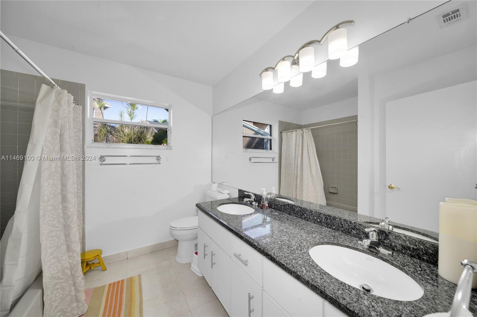 12083 Rockwell Way Boca Raton, FL 33428 - Photo 17 of 47 a bathroom with a granite countertop sink mirror vanity and toilet