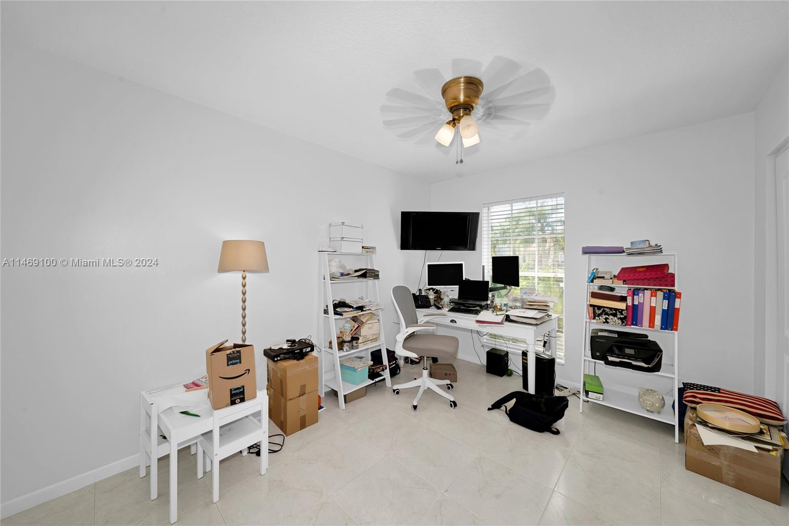 12083 Rockwell Way Boca Raton, FL 33428 - Photo 20 of 47 a view of a workspace with furniture and a flat screen tv