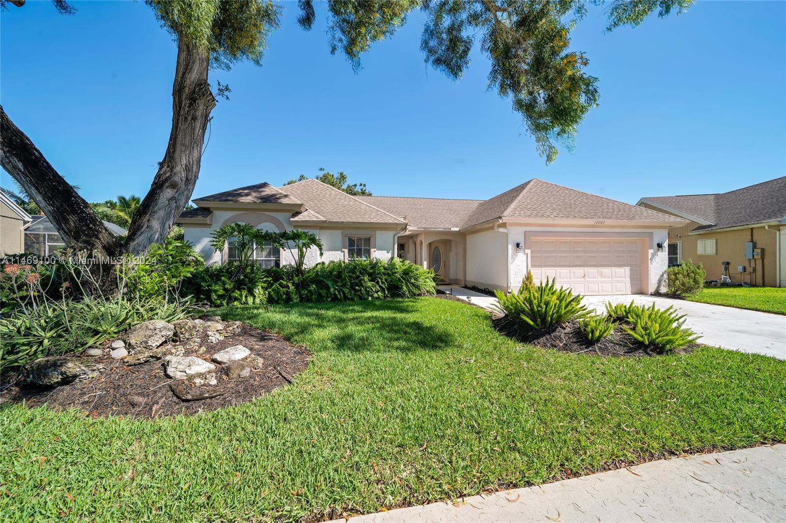 12083 Rockwell Way Boca Raton, FL 33428 - Photo 2 of 47 a view of a front of a house with a yard
