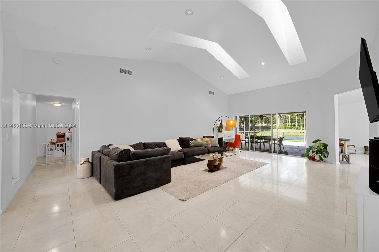 12083 Rockwell Way Boca Raton, FL 33428 - Photo 22 of 47 a living room with furniture and a flat screen tv