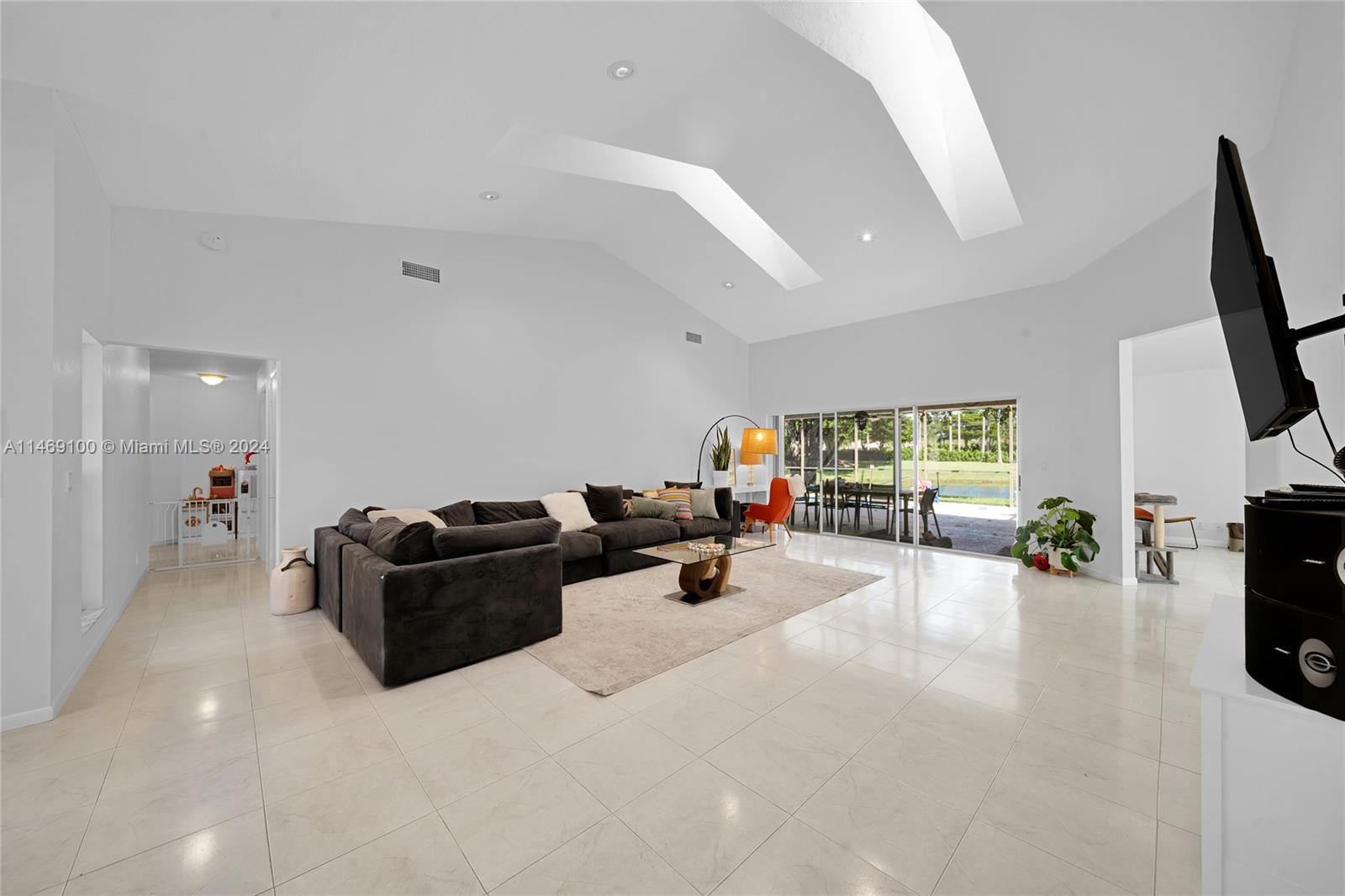 12083 Rockwell Way Boca Raton, FL 33428 - Photo 23 of 47 a living room with furniture and a flat screen tv