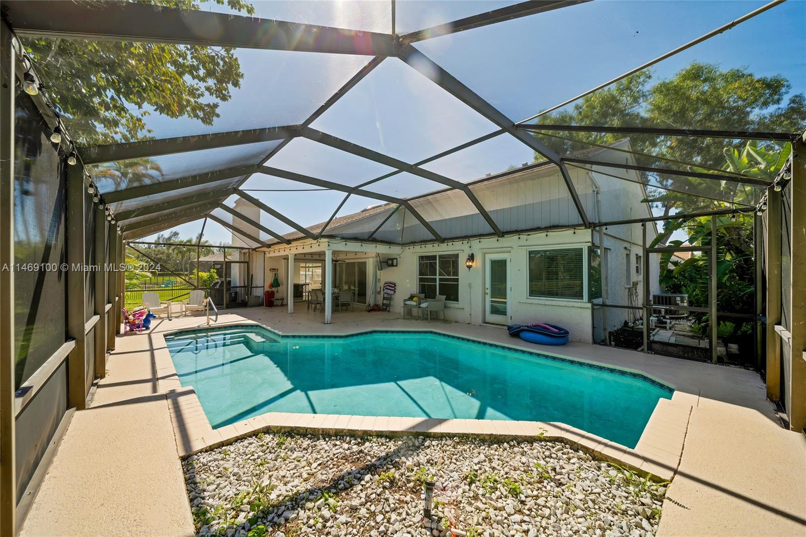12083 Rockwell Way Boca Raton, FL 33428 - Photo 30 of 47 a view of a patio with a table and chairs under an umbrella