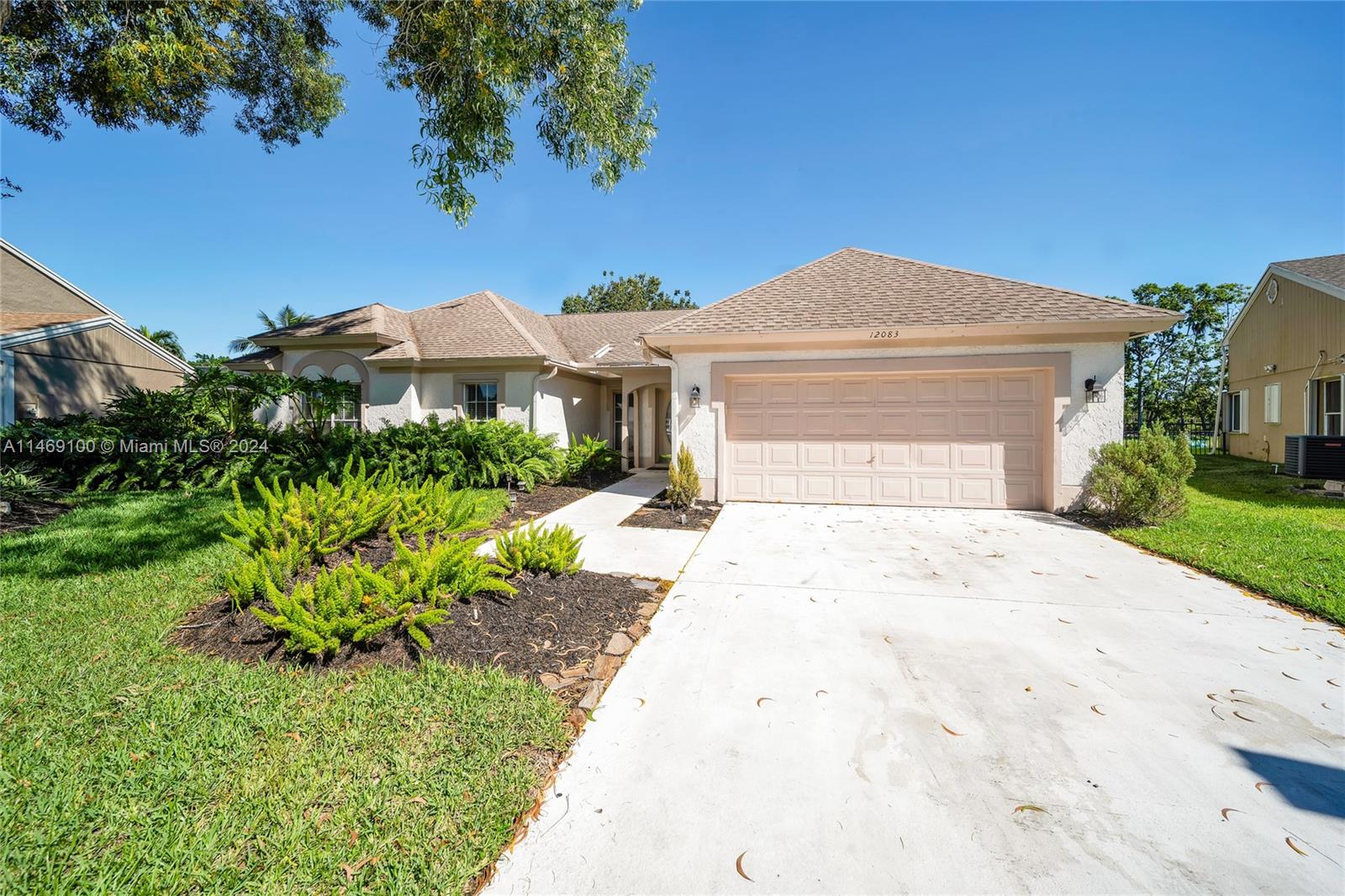 12083 Rockwell Way Boca Raton, FL 33428 - Photo 3 of 47 a front view of a house with a yard