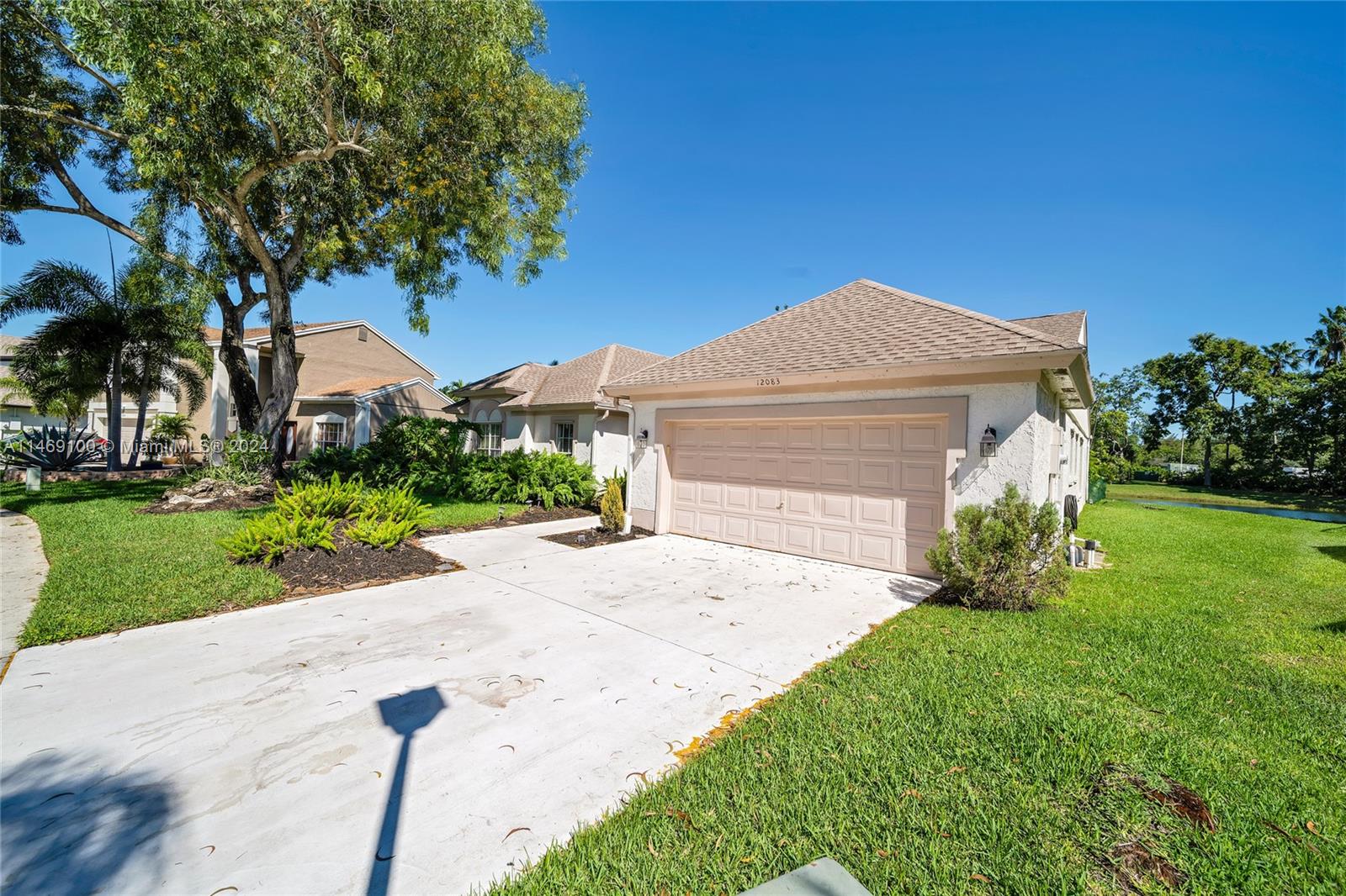 12083 Rockwell Way Boca Raton, FL 33428 - Photo 4 of 47 a front view of a house with a yard and garage