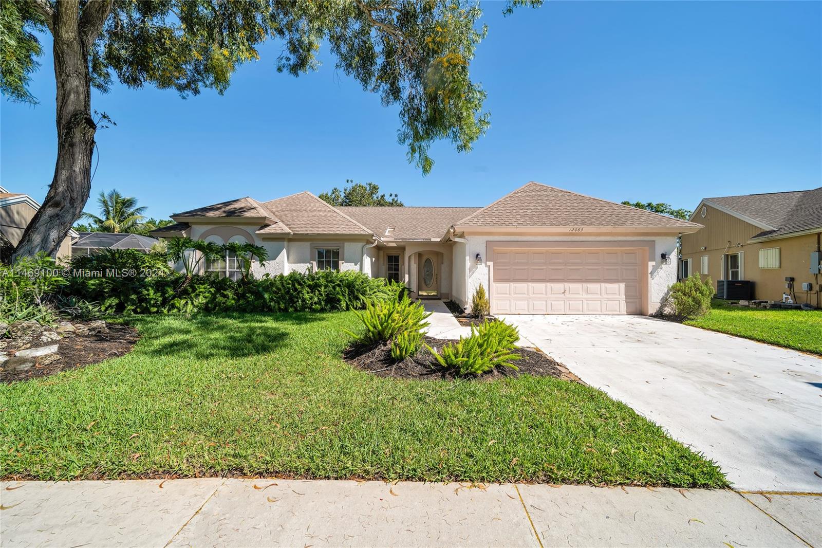 12083 Rockwell Way Boca Raton, FL 33428 - Photo 6 of 47 a front view of a house with a yard