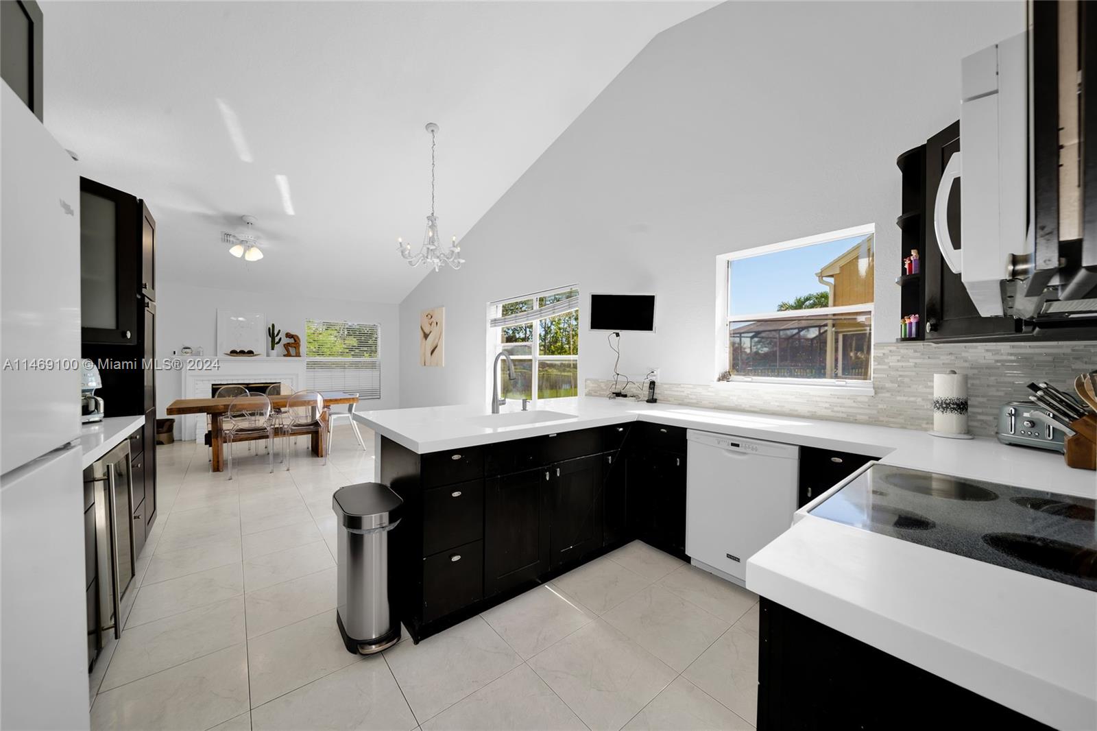 12083 Rockwell Way Boca Raton, FL 33428 - Photo 8 of 47 a large white kitchen with a stove a sink a microwave and refrigerator