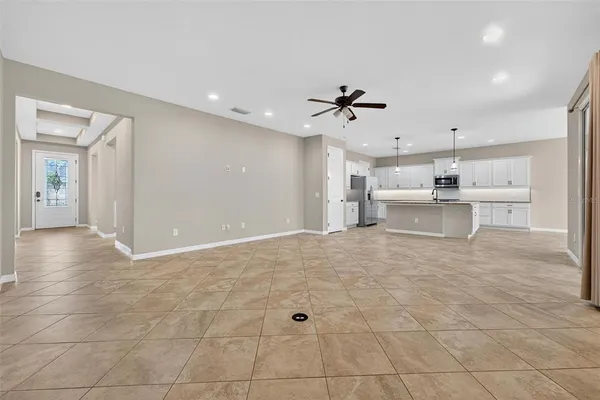 a kitchen with kitchen island a counter top a stove a refrigerator and a sink