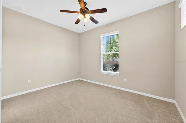 an aerial view of a house with a garden and lake view