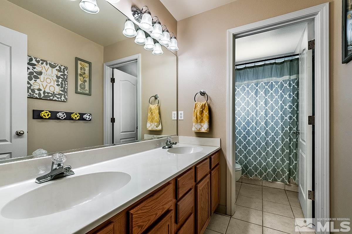 734 Gold River Court Reno, NV 89521 - Photo 13 of 21 a bathroom with a double vanity sink mirror and shower