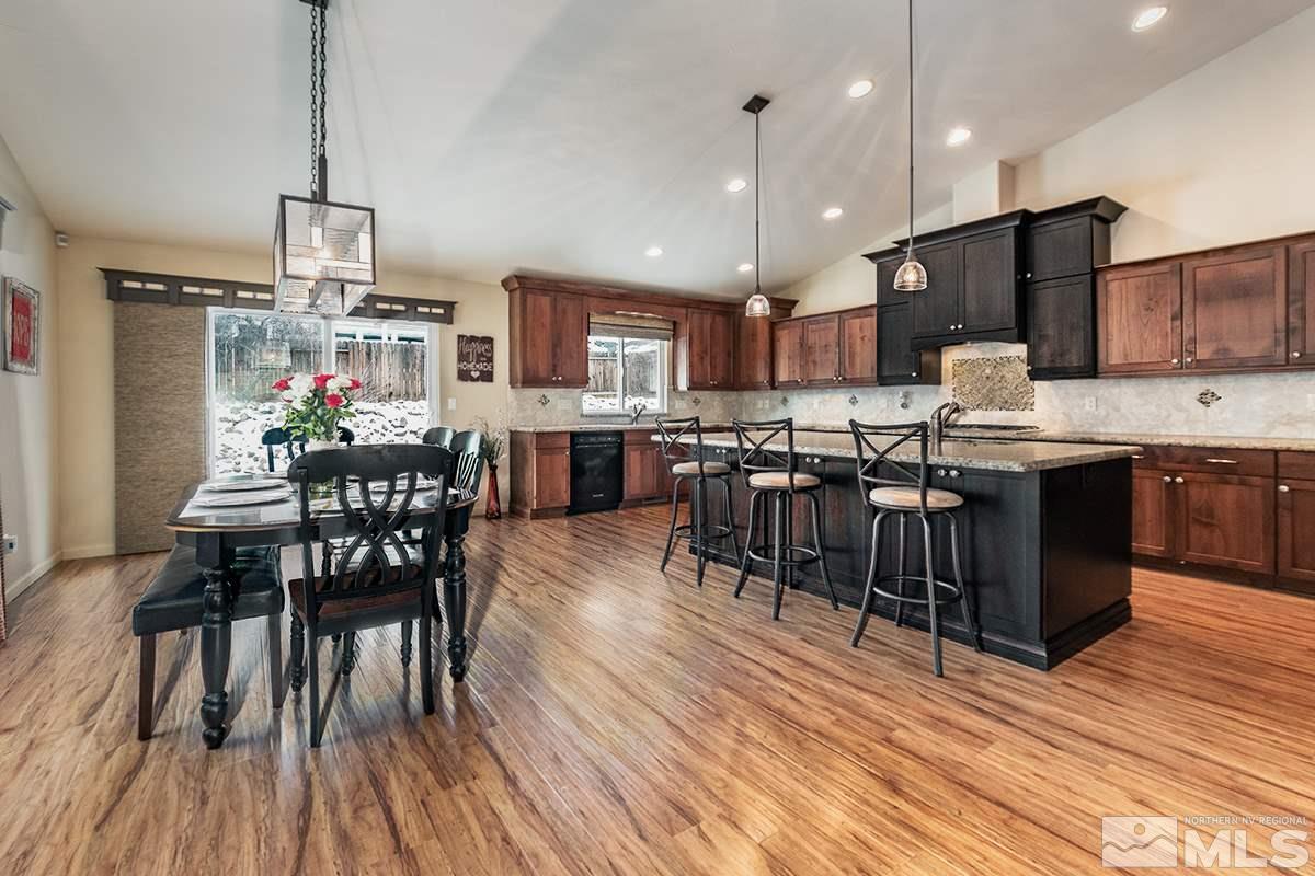 734 Gold River Court Reno, NV 89521 - Photo 5 of 21 a view of a dining room with furniture wooden floor and chandelier