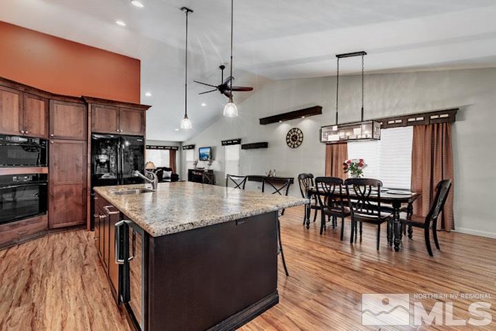 734 Gold River Court Reno, NV 89521 - Photo 7 of 21 a kitchen with stainless steel appliances granite countertop a kitchen island a stove a table and chairs
