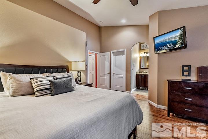 734 Gold River Court Reno, NV 89521 - Photo 9 of 21 a bedroom with a large bed and a tv