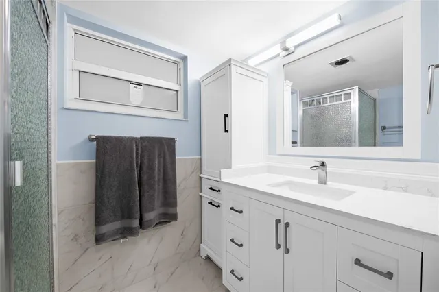 a bathroom with a double vanity sink and mirror