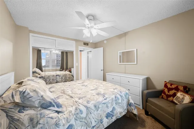 a bedroom with a bed and ceiling fan