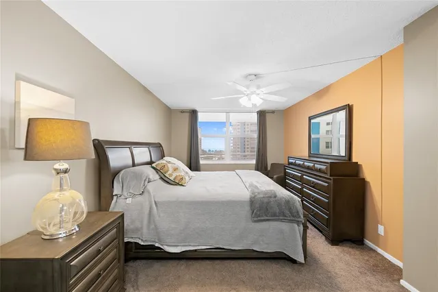 a bedroom with a bed and dresser with mirror