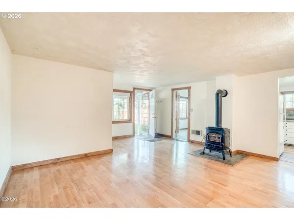 a big room with wooden floor and windows