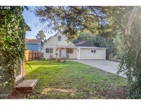 a view of a house with backyard and a sitting area