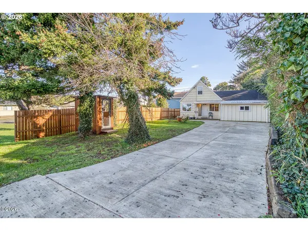 a very nice looking house with a big yard and large trees