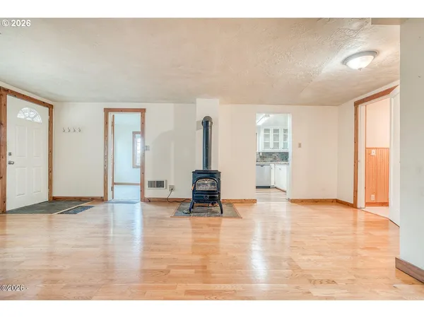 a view of an empty room and wooden floor